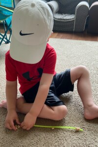 Preschooler making bird feeder